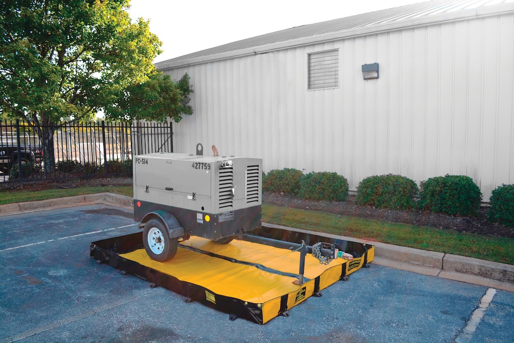Rental generator positioned on a portable spill containment berm