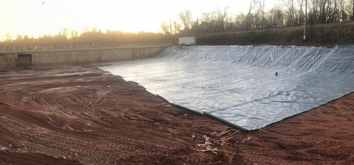 A waterproof liner being installed at an oil tank farm